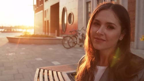 Stylish Woman Smiling in Warm Sunset Light