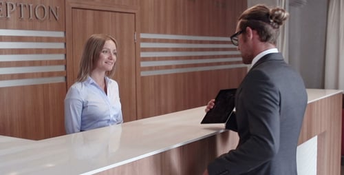 Hotel Receptionist Talking to Hotel Guest