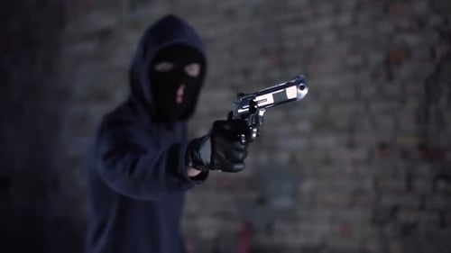 Masked Man Points Handgun Towards Camera