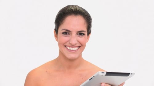 Woman Using Tablet Device In Front of White Background