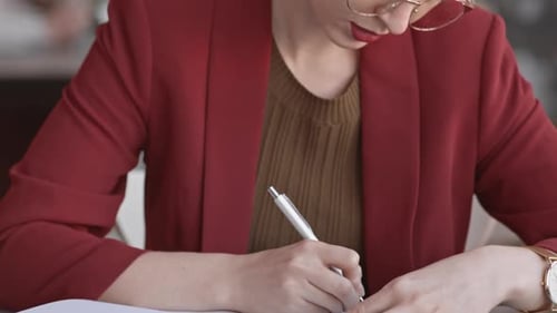 Female Lawyer Writing in Notebook