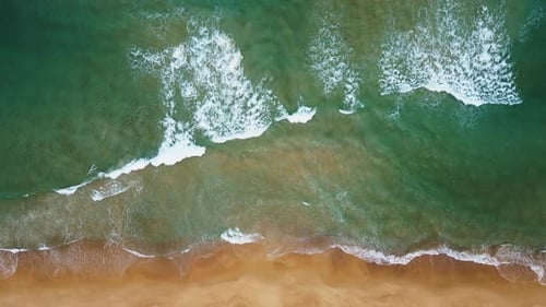 Aerial view of white sand beach and ocean wave