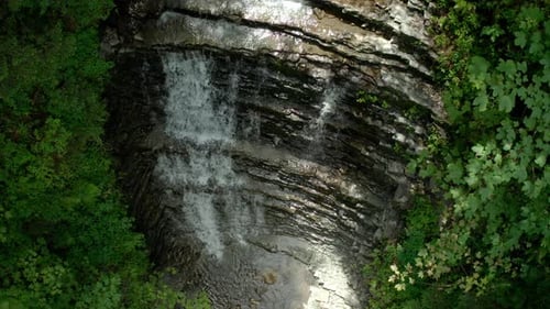 Aerial Drone View Waterfall in the Forest in Sunlight