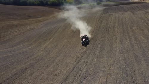 Farmer Plowing Ground Soil with Tractor in Agriculture Field Aerial View