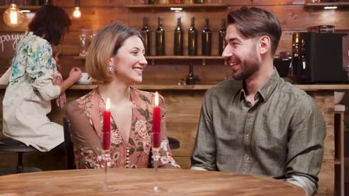 Happy Couple Celebrating with Wine at Intimate Bar