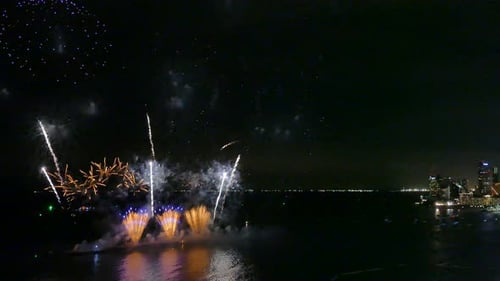 Spectacular Fireworks Display Over Ocean at Night