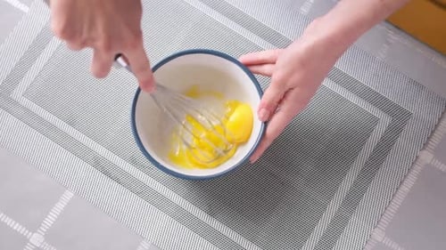 Apple Pie Cake Preparation Series Woman Beat Eggs in a Glass Bowl with a Whisk