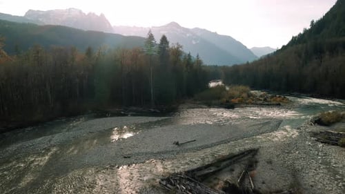 Stunning Fall Season Aerial Over Forest River With Mountain Range Background