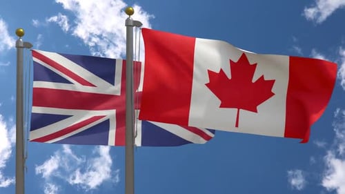 United Kingdom and Canada Flags Waving in Blue Sky