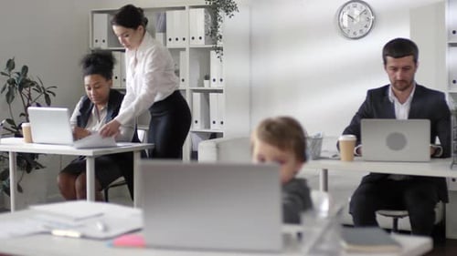 Little Kid Using Laptop in the Office while Mom Busy at Work
