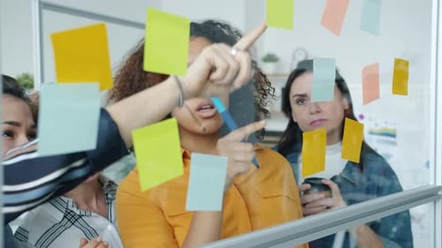 Team of Women Brainstorming with Sticky Notes