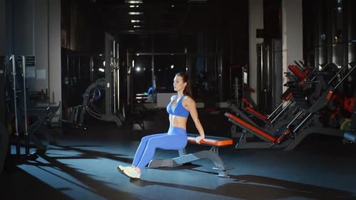 Female Bodybuilder Training Hands and Back Exercising With Bench Chest Workout in Gym