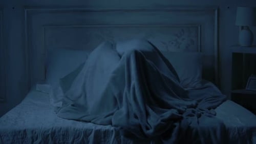 Scared Couple in Bed at Night