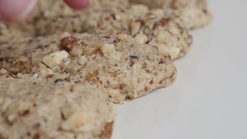 Close Up of Nut Cookies Being Touched