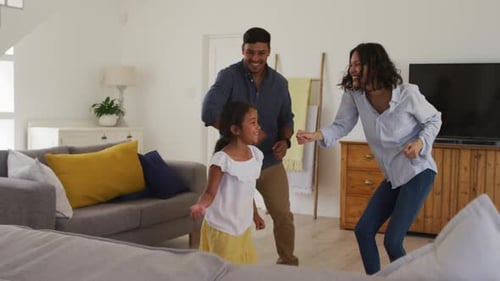 Family Dancing Together in Living Room at Home