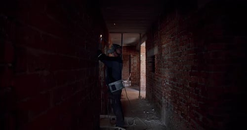 Slow Motion. Worker in a Mask, Welder Welding The Worker Performs Metal Welding at the Factory or