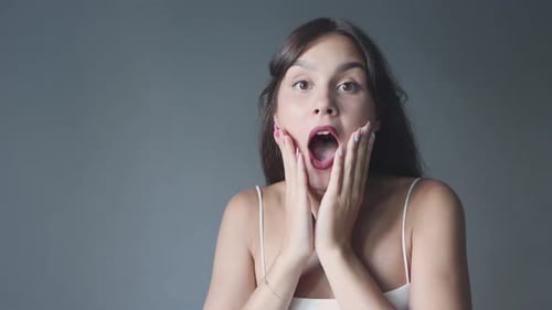 Shocked Woman Points a Finger With Stern Expression