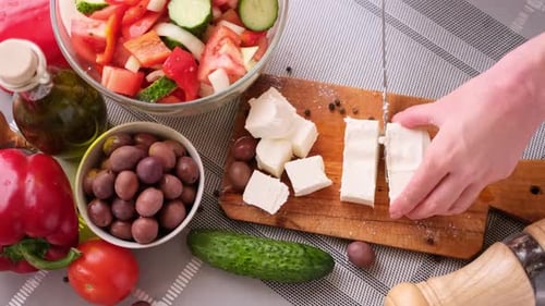 Concept de la série de préparation de salade grecque femme coupant le fromage feta