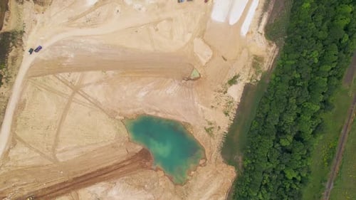 Sand Mining Plant with Machinery on White Sand and Bue Water Lake