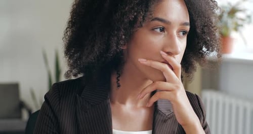 Woman With Curly Hair Thinking, Touching Head