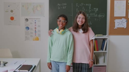 Smiling Teens Standing Together in Classroom