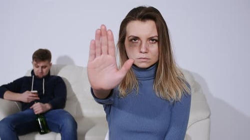 Woman Holds Hand Up in Stop Gesture