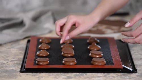 Assembling Chocolate Sandwich Cookies at Home