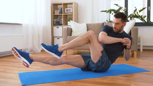 Man Making Abdominal Exercises at Home
