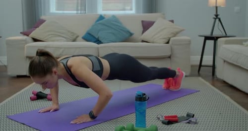 Young Woman Doing Push Ups Indoors