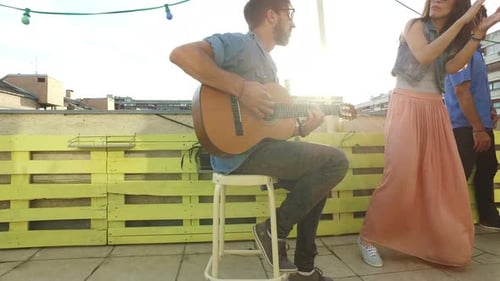 Young Adults Enjoying Music on a Rooftop