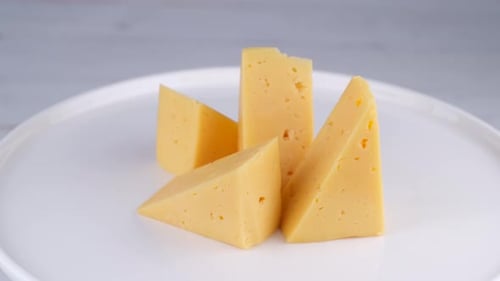 Delicious Cheese Wedges on a White Plate