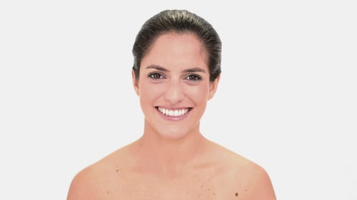 Woman Drinks from Paper Cup and Smiles