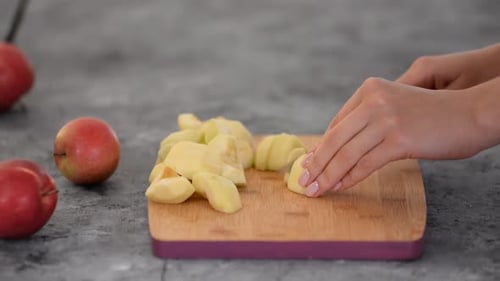 Woman Cut Apple At Kitchen