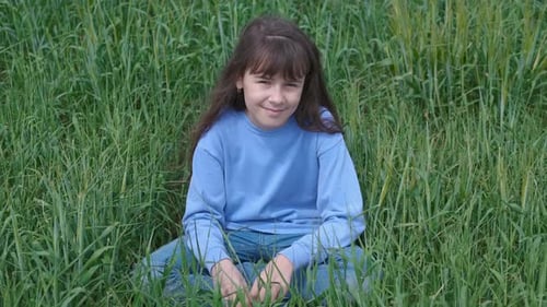 A child in a field outside the city.
