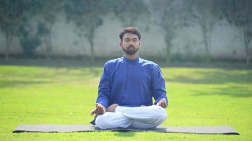 Man Meditating Outdoors on a Yoga Mat