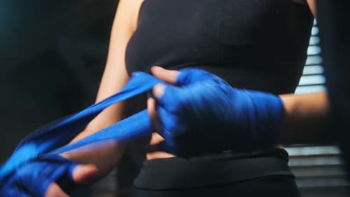 Woman Wrapping Hands for Boxing