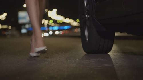 Female Legs in High Heels Walk on Roadside at Dusk