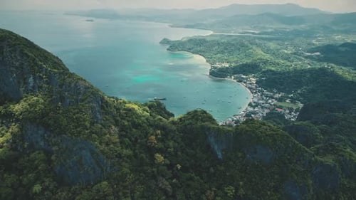 Mountainous Tropical Island Aerial: Pier Town Cityscape with Vessels, Boats on Water. Green Forest