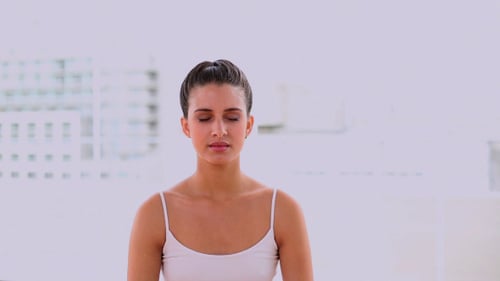 Woman Performs Yoga in Bright Studio