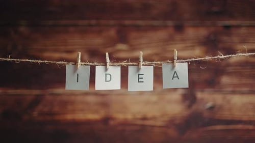 Hanging Notes Spelling 'Idea' on Twine