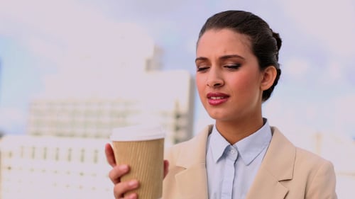 Woman Enjoying Coffee Outside Office Building