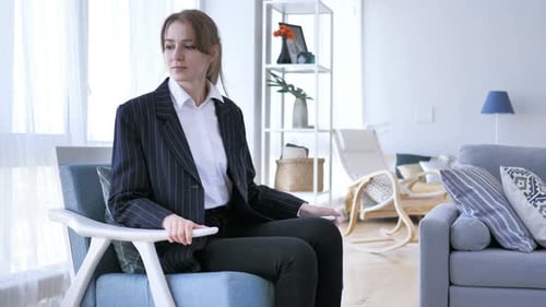 Business Woman Sitting in Modern Chair