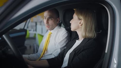 Car Salesperson Explains Features to a Woman