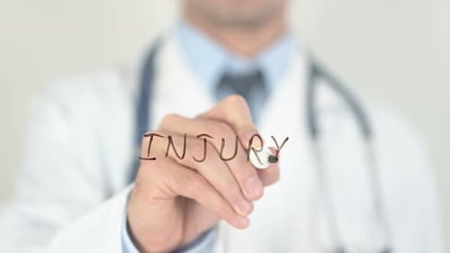 Doctor Writes Injury with Marker Close Up