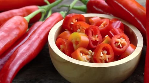 Red Chili Peppers and Sliced Peppers in Bowl