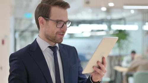 Businessman Having Video Conference Call on Tablet