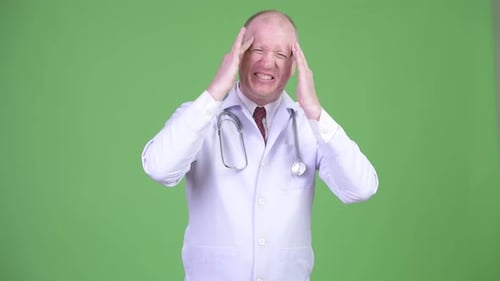 Doctor Experiencing Bad Headache, Rubbing Temples