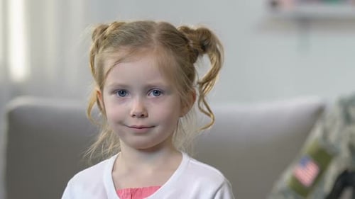 Smiling Child with Soldier in Army Camouflage Uniform