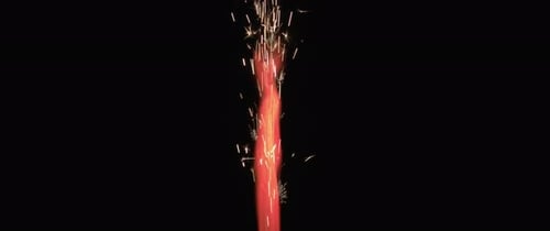 Red flame and sparks coming out of a firework.
