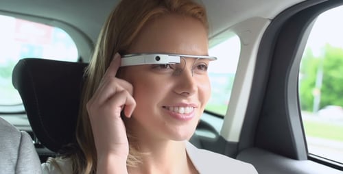 Woman Using Augmented Reality Glasses in Car
